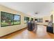 Open-concept living room features a bar and abundant natural light from large windows at 5237 Gateway Ave, Orlando, FL 32821