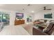 Cozy living room with tile flooring, comfortable furnishings, and access to the outdoor patio at 5237 Gateway Ave, Orlando, FL 32821