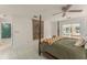 Bright main bedroom with a decorative rug, four-poster bed, and doors to the lanai at 5237 Gateway Ave, Orlando, FL 32821