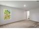 A bedroom with neutral carpet, a window, and a closet offers a peaceful retreat at 667 Bay Leaf Dr, Kissimmee, FL 34759