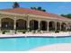 Beautiful community clubhouse with an inviting pool surrounded by manicured landscaping at 667 Bay Leaf Dr, Kissimmee, FL 34759