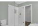 Bathroom featuring a white tiled walk-in shower with glass door, gold hardware, and a tiled base at 762 Lake Como Dr, Lake Mary, FL 32746