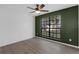 Bedroom with wood-look flooring, neutral paint, a modern ceiling fan, and a large window for natural light at 762 Lake Como Dr, Lake Mary, FL 32746
