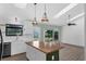 Sunlit kitchen with butcher block island, open shelving, and a view to the outside at 762 Lake Como Dr, Lake Mary, FL 32746