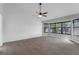 Bright living room featuring wood-look flooring, ceiling fan, and multiple windows for natural light at 762 Lake Como Dr, Lake Mary, FL 32746