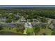 Aerial view of home with screened pool in established neighborhood with pond; view of the surrounding area at 856 Bentley Green Cir, Winter Springs, FL 32708