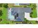 Aerial view of home featuring screened pool, solar panels, and pristine landscaping, offering both luxury and sustainability at 856 Bentley Green Cir, Winter Springs, FL 32708