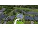 An aerial view of a single-story home near a pond and golf course, surrounded by lush greenery at 856 Bentley Green Cir, Winter Springs, FL 32708