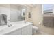 Well-lit bathroom featuring double sinks, a large mirror, and a shower with a white tile surround at 856 Bentley Green Cir, Winter Springs, FL 32708