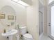 Bathroom with a stand alone sink, toilet, and a walk-in shower with grab bars for assistance at 856 Bentley Green Cir, Winter Springs, FL 32708