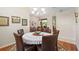 Bright dining area features chandelier lighting, hardwood floors, and adjacent sitting room at 856 Bentley Green Cir, Winter Springs, FL 32708