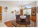 An elegant dining room with decorative rug, wooden floors, and a table set for six at 856 Bentley Green Cir, Winter Springs, FL 32708