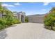 Charming one-story home with a three-car garage, lush landscaping, and a brick paver driveway under a bright sky at 856 Bentley Green Cir, Winter Springs, FL 32708