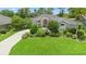 Charming single-story home with mature landscaping, lush green lawn and a patterned brick driveway at 856 Bentley Green Cir, Winter Springs, FL 32708