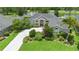 Charming single-story home with mature landscaping, lush green lawn and a patterned brick driveway at 856 Bentley Green Cir, Winter Springs, FL 32708