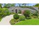 Charming home with lush landscaping, a circular driveway, and an inviting entrance, creating excellent curb appeal at 856 Bentley Green Cir, Winter Springs, FL 32708