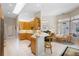 Bright kitchen with light wood cabinets, stainless appliances, and breakfast bar seating at 856 Bentley Green Cir, Winter Springs, FL 32708