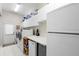 Bright laundry room with white appliances, cabinets, and plenty of counter space for folding clothes and storage at 856 Bentley Green Cir, Winter Springs, FL 32708
