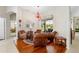 Bright sitting room with hardwood floors, comfortable seating, and a view of the screened-in pool area at 856 Bentley Green Cir, Winter Springs, FL 32708
