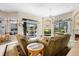 Spacious living room featuring plush sofas, large windows with backyard views and seamless access to the outdoors at 856 Bentley Green Cir, Winter Springs, FL 32708