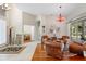 Bright sitting room with hardwood floors, comfortable seating, and a view of the screened-in pool area at 856 Bentley Green Cir, Winter Springs, FL 32708