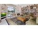 Inviting living room features a fireplace, a large bookshelf, and views of the outdoor pool and patio at 856 Bentley Green Cir, Winter Springs, FL 32708