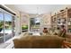 Bright living room features a built-in bookcase, fireplace, and view of the pool through sliding glass doors at 856 Bentley Green Cir, Winter Springs, FL 32708