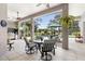 Screened patio featuring a table with chairs, ceiling fans, and hanging plants near the pool and backyard at 856 Bentley Green Cir, Winter Springs, FL 32708