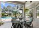 Relaxing screened patio with outdoor seating overlooking the pool and lush landscaping with green umbrella at 856 Bentley Green Cir, Winter Springs, FL 32708