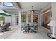 Enclosed patio with a table and chairs, ceiling fan, and views of the backyard and mature trees at 856 Bentley Green Cir, Winter Springs, FL 32708