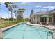 Sparkling swimming pool and spa enclosed by a screen with views of the lush landscaping and greenery at 856 Bentley Green Cir, Winter Springs, FL 32708