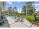 Covered patio and pool area with patio furniture, landscaping, and a view of the well-maintained backyard at 856 Bentley Green Cir, Winter Springs, FL 32708