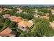 Aerial view of neighborhood featuring mature trees, manicured lawns, and a lake view in the background at 9128 Phillips Grove Ter, Orlando, FL 32836