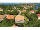 Aerial view of home with screened in lanai, lush landscaping, and neighborhood lake view at 9128 Phillips Grove Ter, Orlando, FL 32836