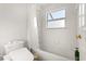 Bathroom featuring a shower and tub combination with white tiles at 9128 Phillips Grove Ter, Orlando, FL 32836