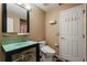 Cozy bathroom with a quirky green sink, modern toilet, and checkered floors at 9128 Phillips Grove Ter, Orlando, FL 32836