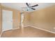 Generous bedroom with two windows, a fan, and a view through the door of the home's staircase at 9128 Phillips Grove Ter, Orlando, FL 32836