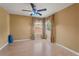 Spacious bedroom with two windows featuring a ceiling fan and neutral walls at 9128 Phillips Grove Ter, Orlando, FL 32836