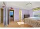 Bedroom with ensuite bathroom, wood floors, and a comfortable bed at 9128 Phillips Grove Ter, Orlando, FL 32836
