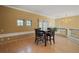 Cozy dining area with wood floors and an elegant chandelier next to the staircase at 9128 Phillips Grove Ter, Orlando, FL 32836
