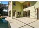 Back of the home with a covered patio and a view of the pool at 9128 Phillips Grove Ter, Orlando, FL 32836