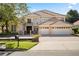 Elegant two-story home with a beautiful tile roof and a spacious three-car garage at 9128 Phillips Grove Ter, Orlando, FL 32836