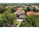 Stunning aerial view of the home highlighting the tile roof, brick driveway, and lush landscaping at 9128 Phillips Grove Ter, Orlando, FL 32836