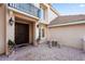 Charming front entrance with a dark wood door, stone patio and a small seating area at 9128 Phillips Grove Ter, Orlando, FL 32836