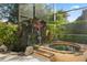 Inviting backyard hot tub with stone waterfall feature and lush tropical landscaping at 9128 Phillips Grove Ter, Orlando, FL 32836