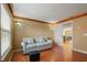 Bright and inviting living room with a comfortable couch and view to staircase at 9128 Phillips Grove Ter, Orlando, FL 32836