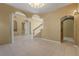 Bright living room with tile floors, arched doorways, and views of the staircase at 9128 Phillips Grove Ter, Orlando, FL 32836