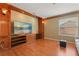 Cozy living room with custom built-in shelving, wood floors, and lots of light at 9128 Phillips Grove Ter, Orlando, FL 32836