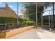 View of the patio with flower bed, screen enclosure, and landscaped backyard at 9128 Phillips Grove Ter, Orlando, FL 32836
