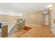 Open concept landing at the top of a staircase with wood floors and access to multiple rooms at 9128 Phillips Grove Ter, Orlando, FL 32836